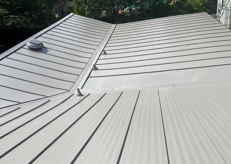 Solar attic fan installed on a metal roof for Roof Ventilation in St. Albans